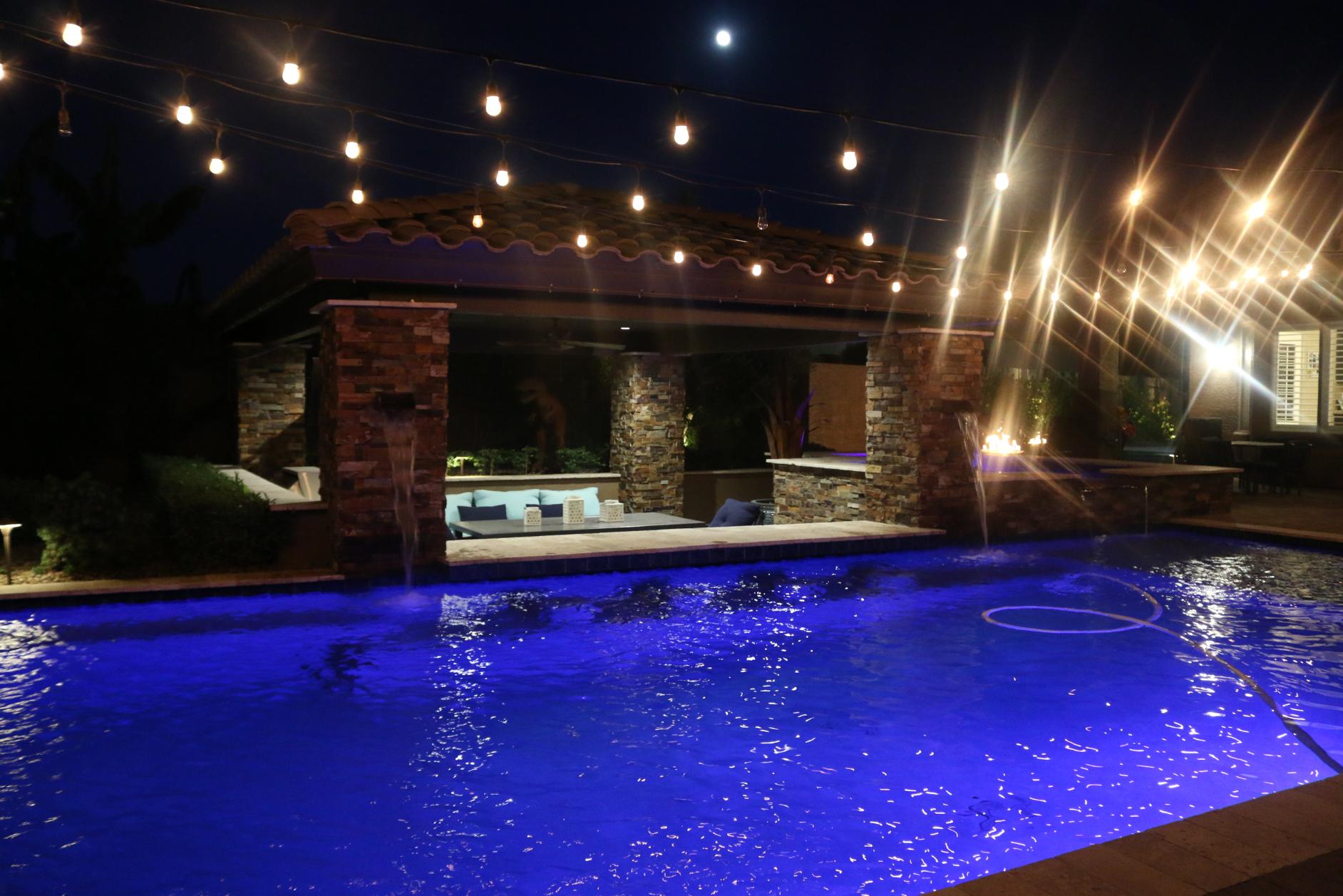 Integrated patio design with pool and surrounding garden elements